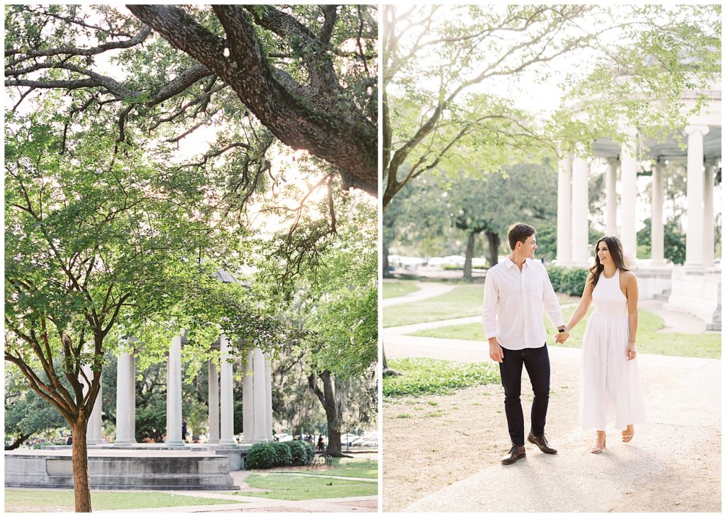A couple wearing a white shirt and a blue dress take engagement pictures in City Park of New Orleans under the large live oak trees at band stand cafe du Monde